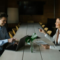 Mies ja nainen keskustelevat pöydän ääressä